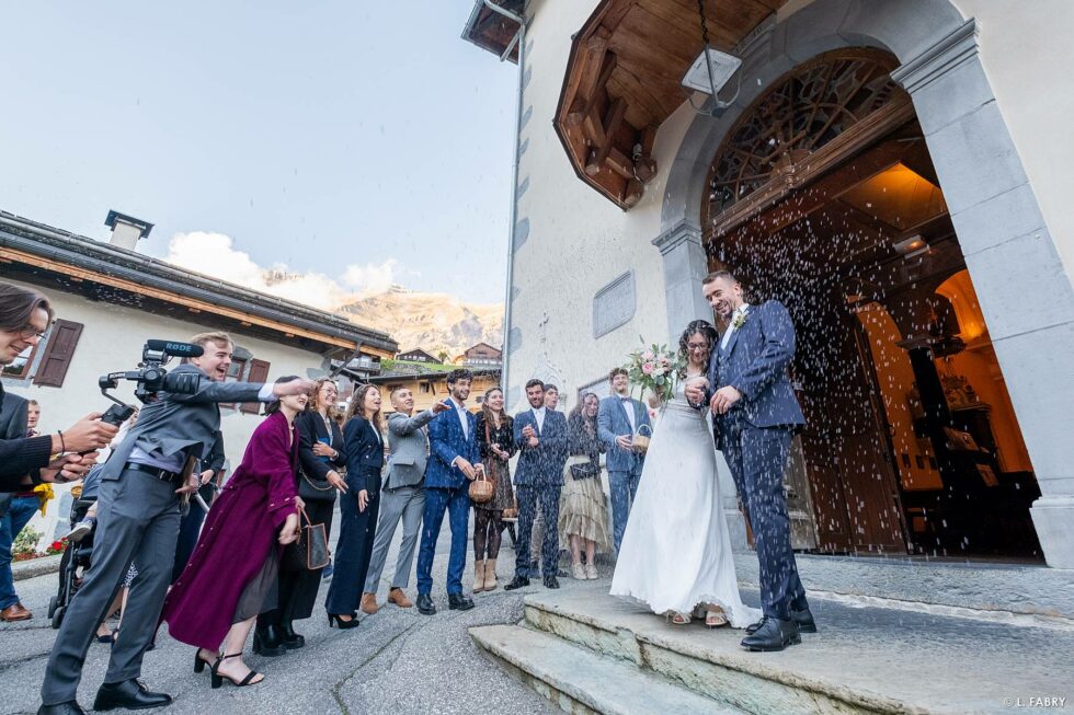 Reportage de mariage en automne à la montagne : sortie d'église des mariés