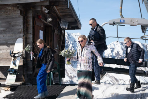 Photographe de mariage à la montagne : les mariés et leurs enfants descendent du télésiège